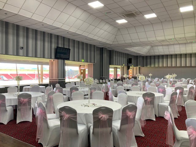 Albert McPherson Lounge at Walsall FC, elegant wedding venue with pink chair sashes.