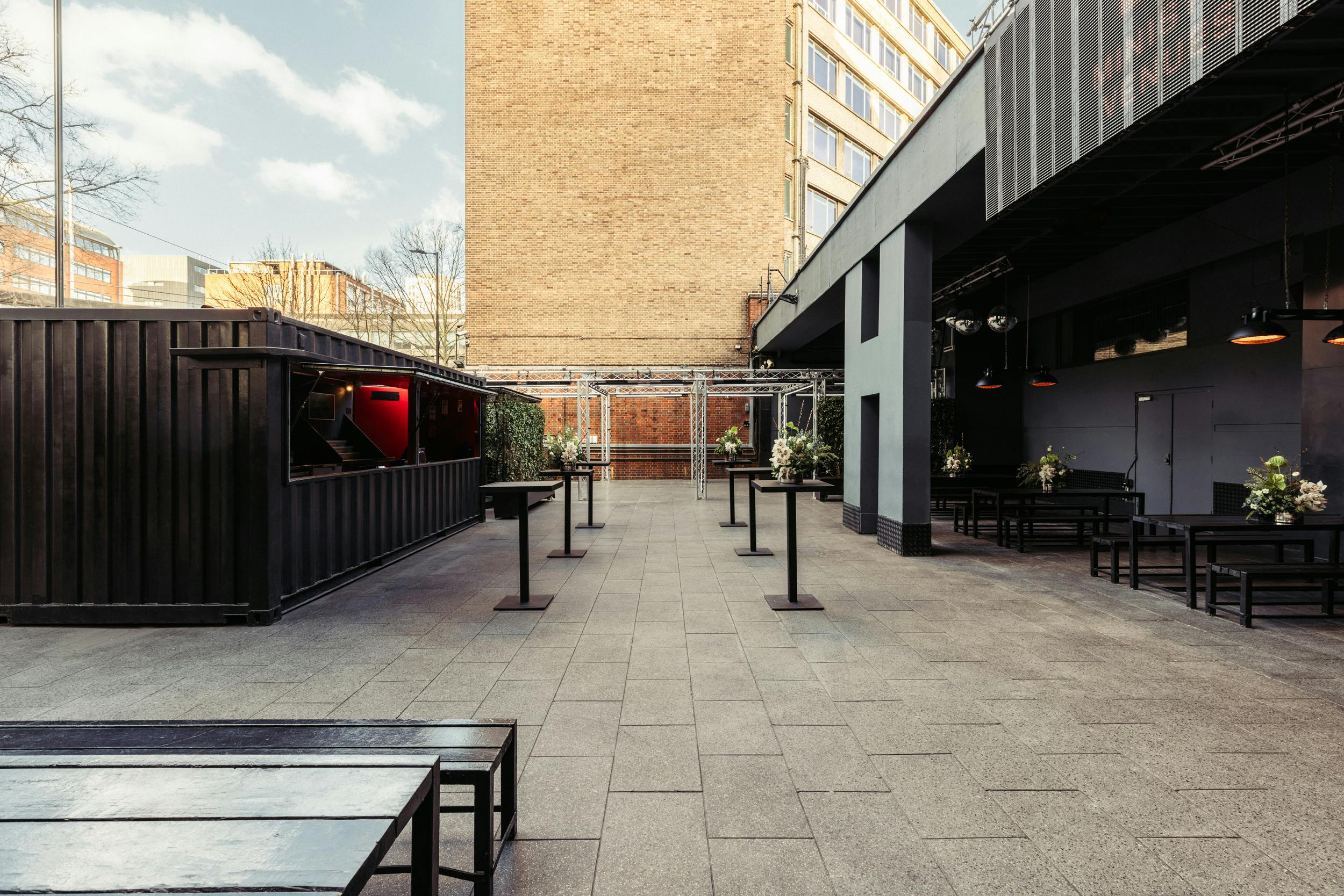 Outdoor event space at Ministry of Sound with sleek design and greenery for gatherings.