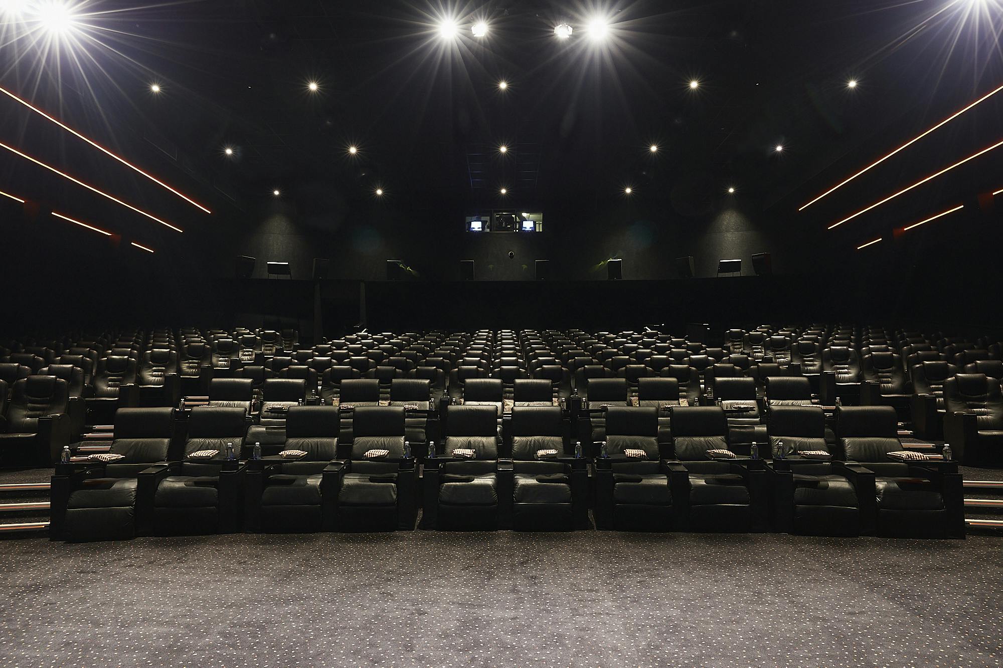 Modern auditorium with plush reclining seats for film screenings and presentations.