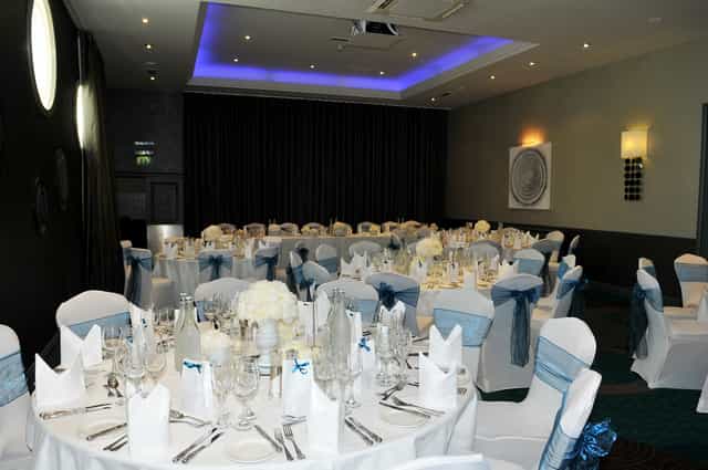Grand Suite banquet setup with elegant tables, perfect for weddings and corporate events.