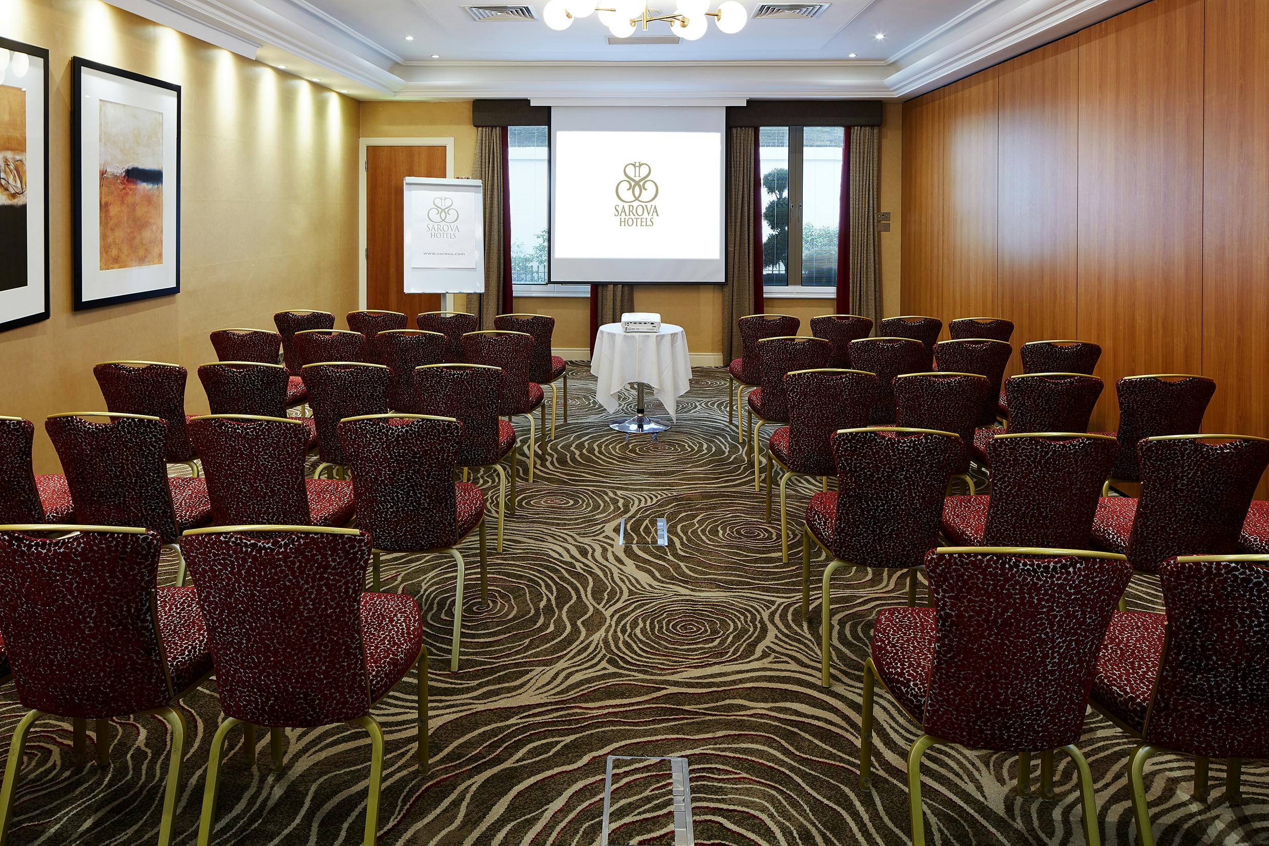 Edward Suite meeting room with projector screen, ideal for corporate events and workshops.