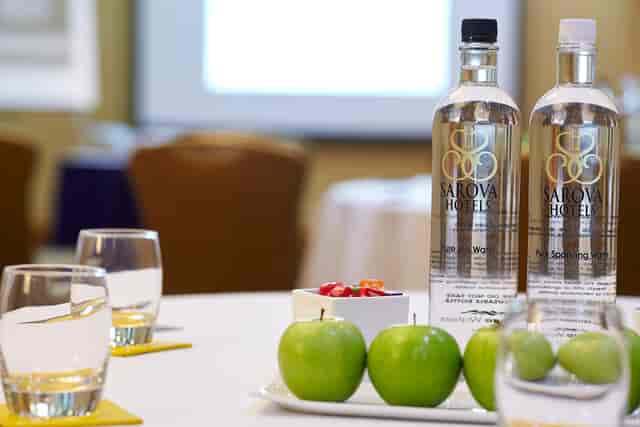 Elegant meeting setup in Edward Suite with fresh apples and water bottles.