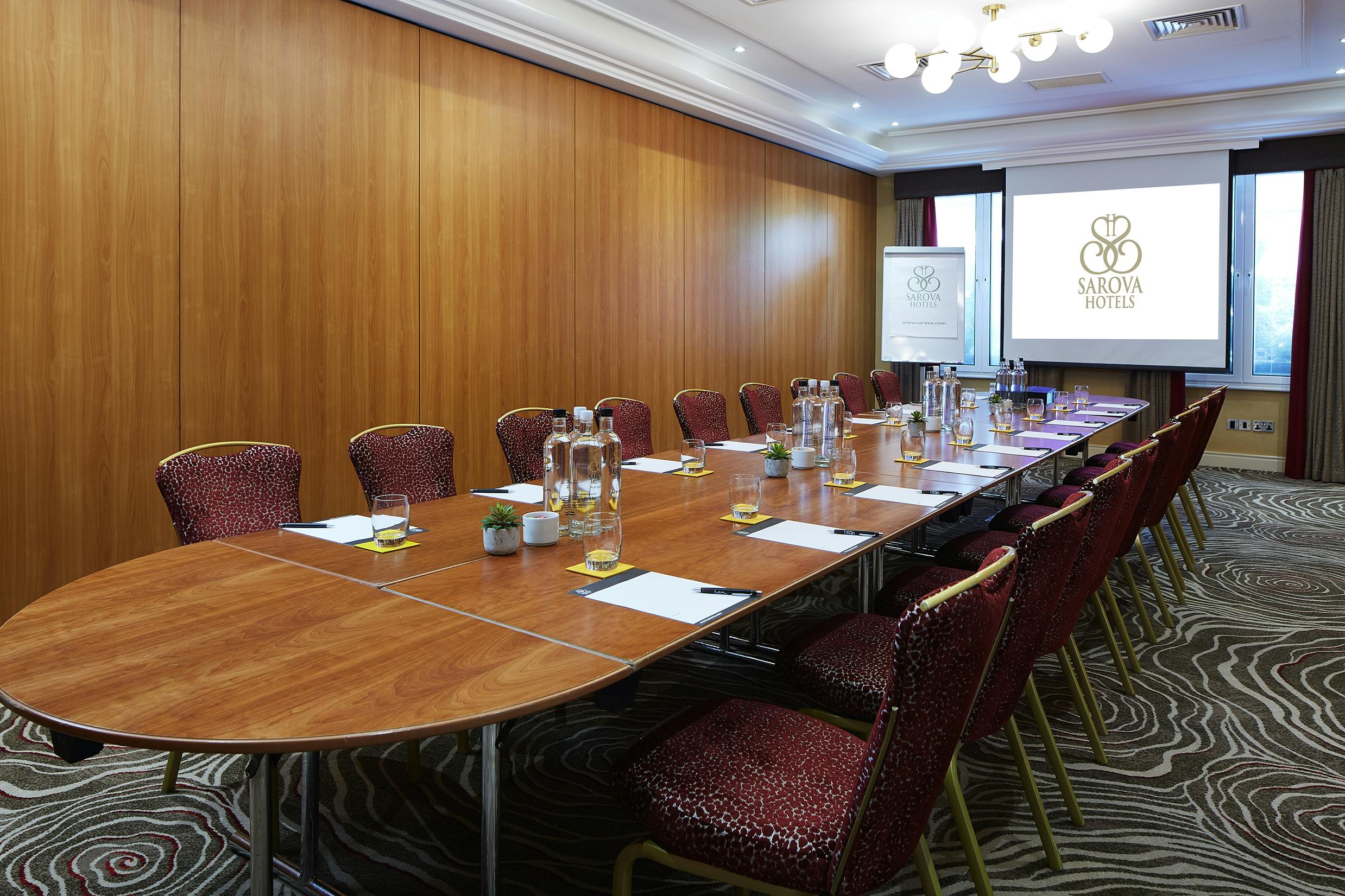 Charles Suite meeting room with oval table, ideal for corporate events and workshops.