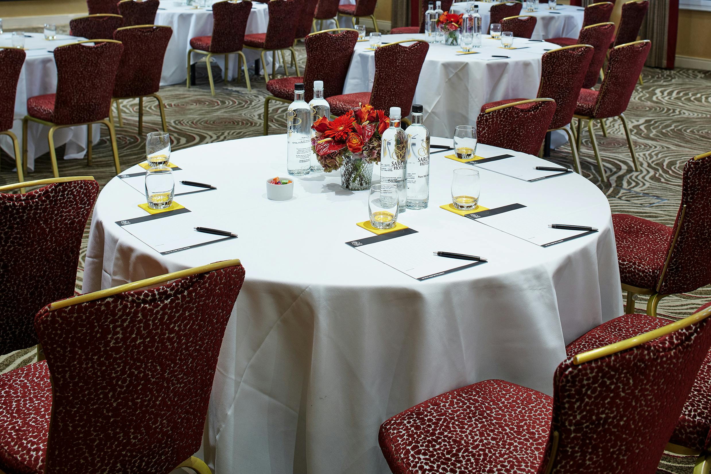 Elizabeth Suite meeting setup with round tables, white linens, and elegant centerpieces.