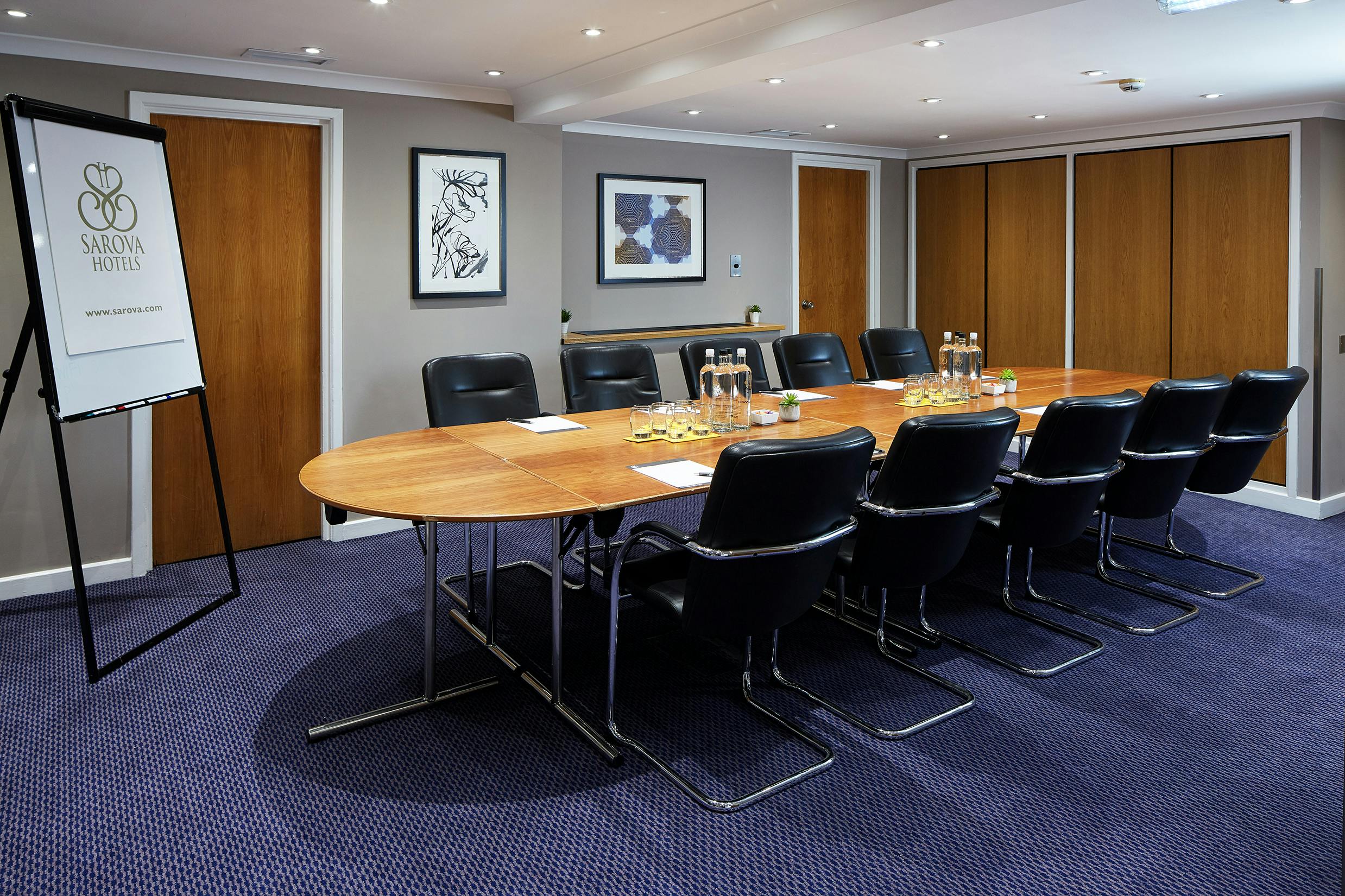 Boardroom at The Rembrandt with oval table, ideal for professional meetings and events.