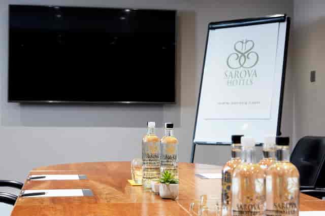 Boardroom at The Rembrandt with polished table, ideal for corporate meetings and presentations.