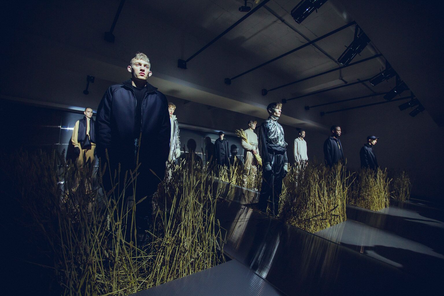 Fashion presentation at Marylebone Gallery with models in tall grass installations. - Banner