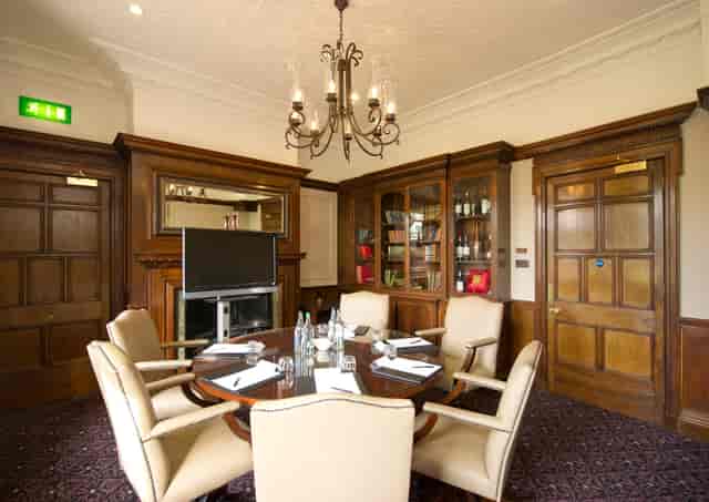 Boardroom at Woodlands Park Hotel with elegant wooden paneling for executive meetings.