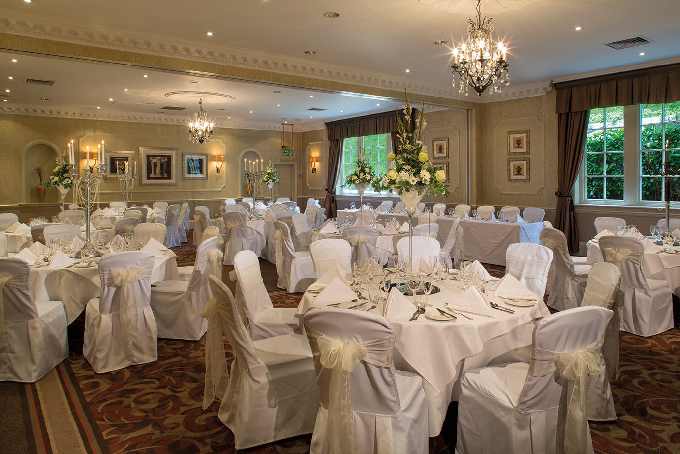 Elegant Vavasour Suite banquet hall for weddings, featuring white linens and chandeliers.