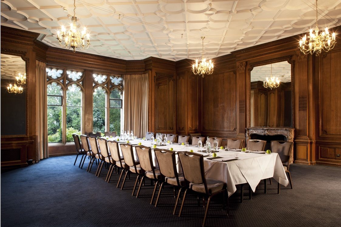 Gibson Room at Nutfield Priory: elegant meeting space with wooden paneling for exclusive events.