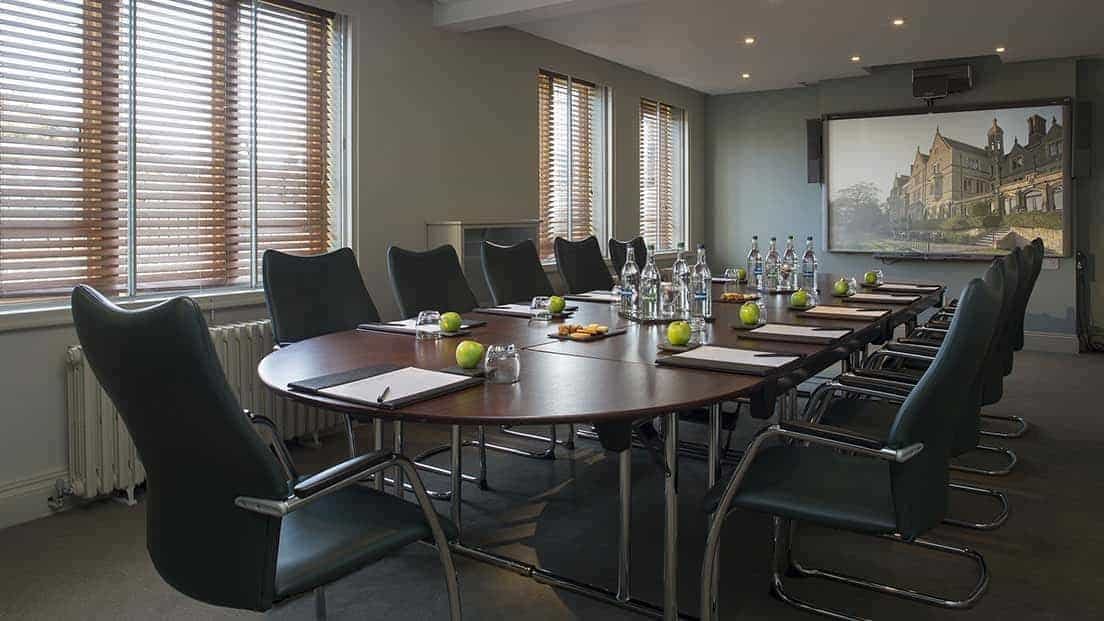 Kenley Room at Nutfield Priory: elegant meeting space with oval table for professional events.