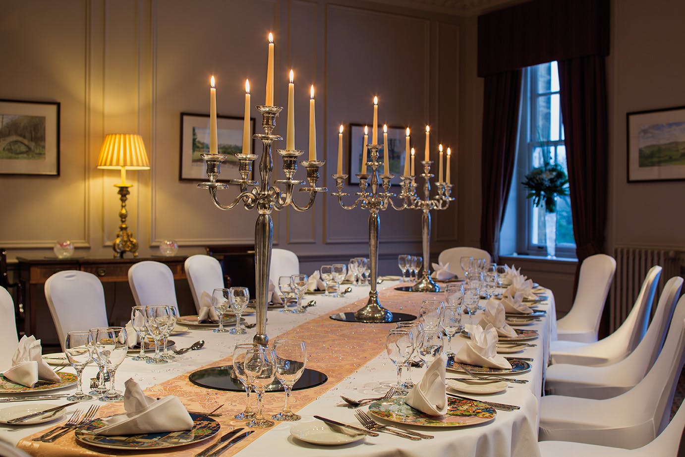 Elegant dining table in Crathorne Hall's Presidents lounge for formal events.