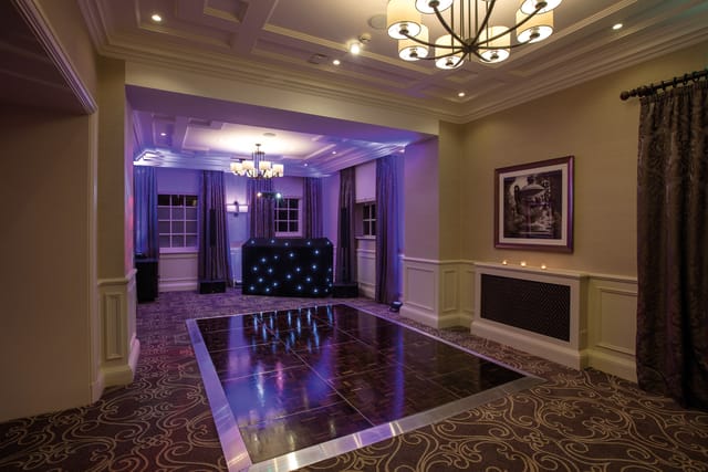 Stylish event space at Crathorne Hall Hotel with sleek dance floor and ambient lighting.