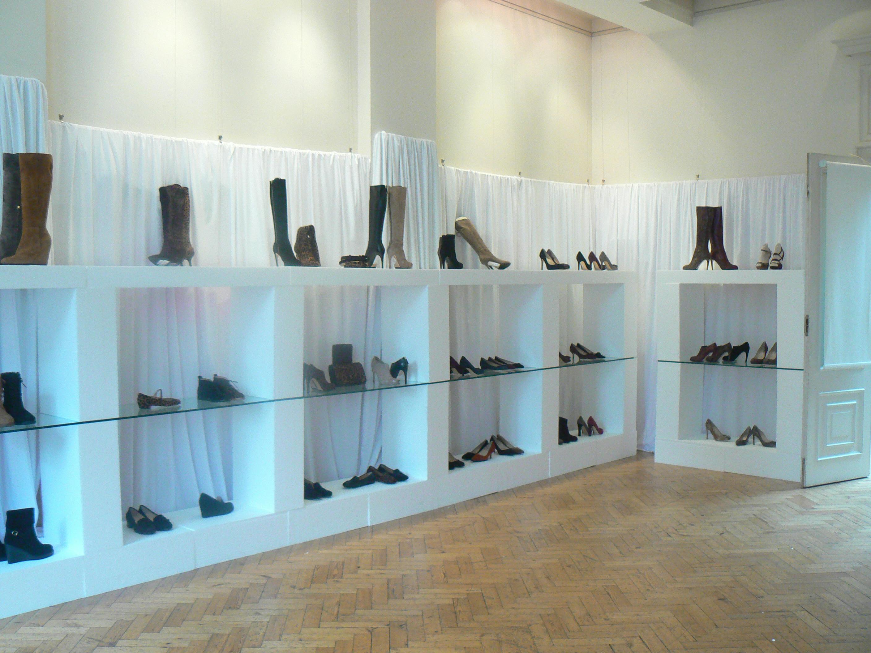Stylish shoe display in a well-lit venue for a fashion event at The Hellenic Centre.