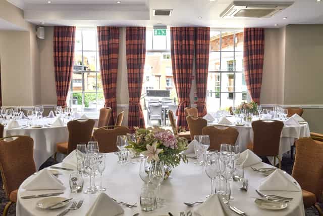 Elegant Princess Suite banquet room with round tables, perfect for weddings and corporate events.