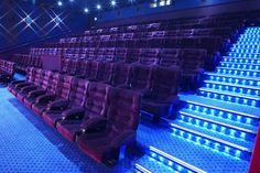 Modern theater with plush seating and illuminated steps for film screenings and presentations.