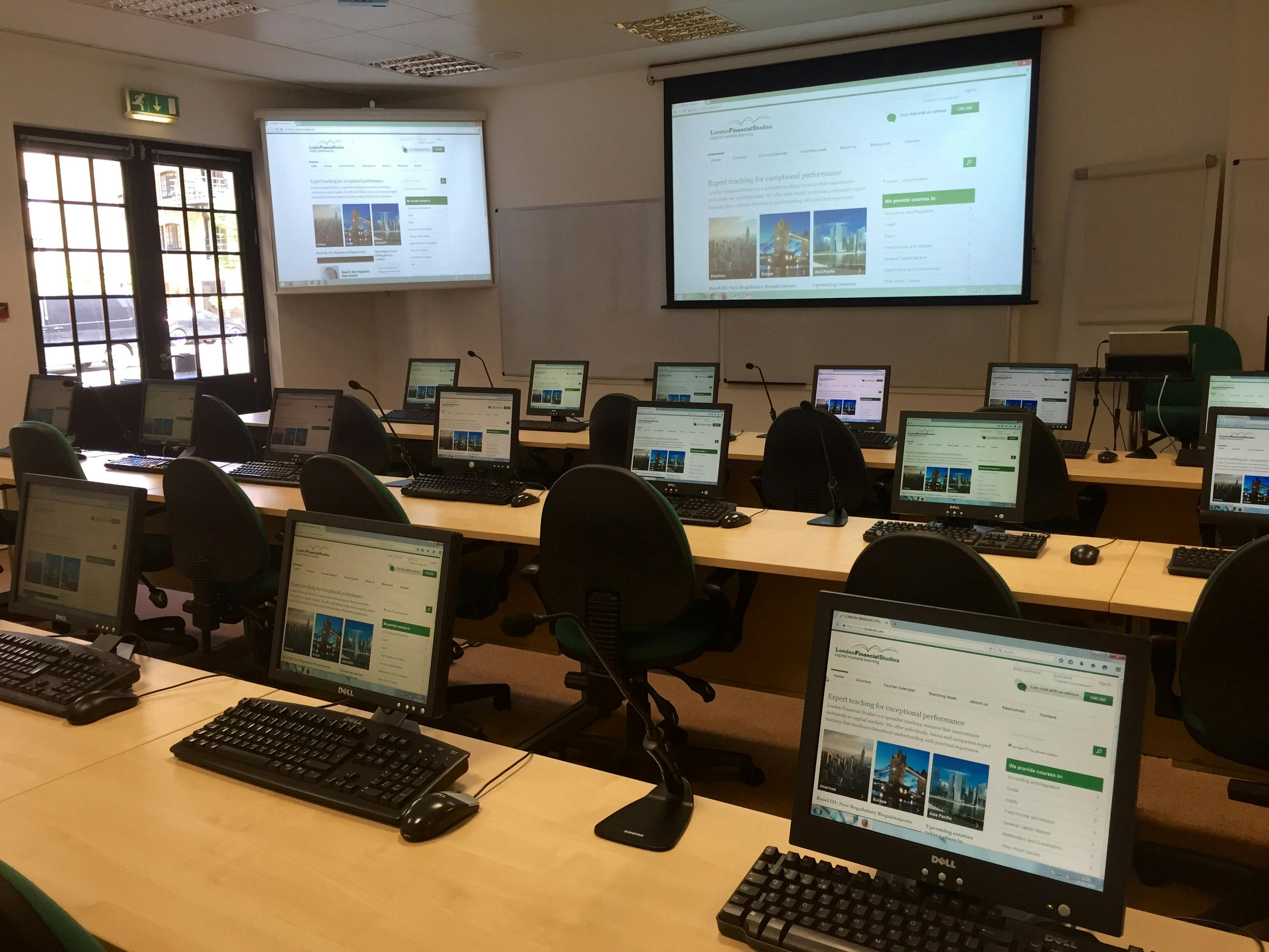 Training room with dual screens for workshops and tech seminars in London.