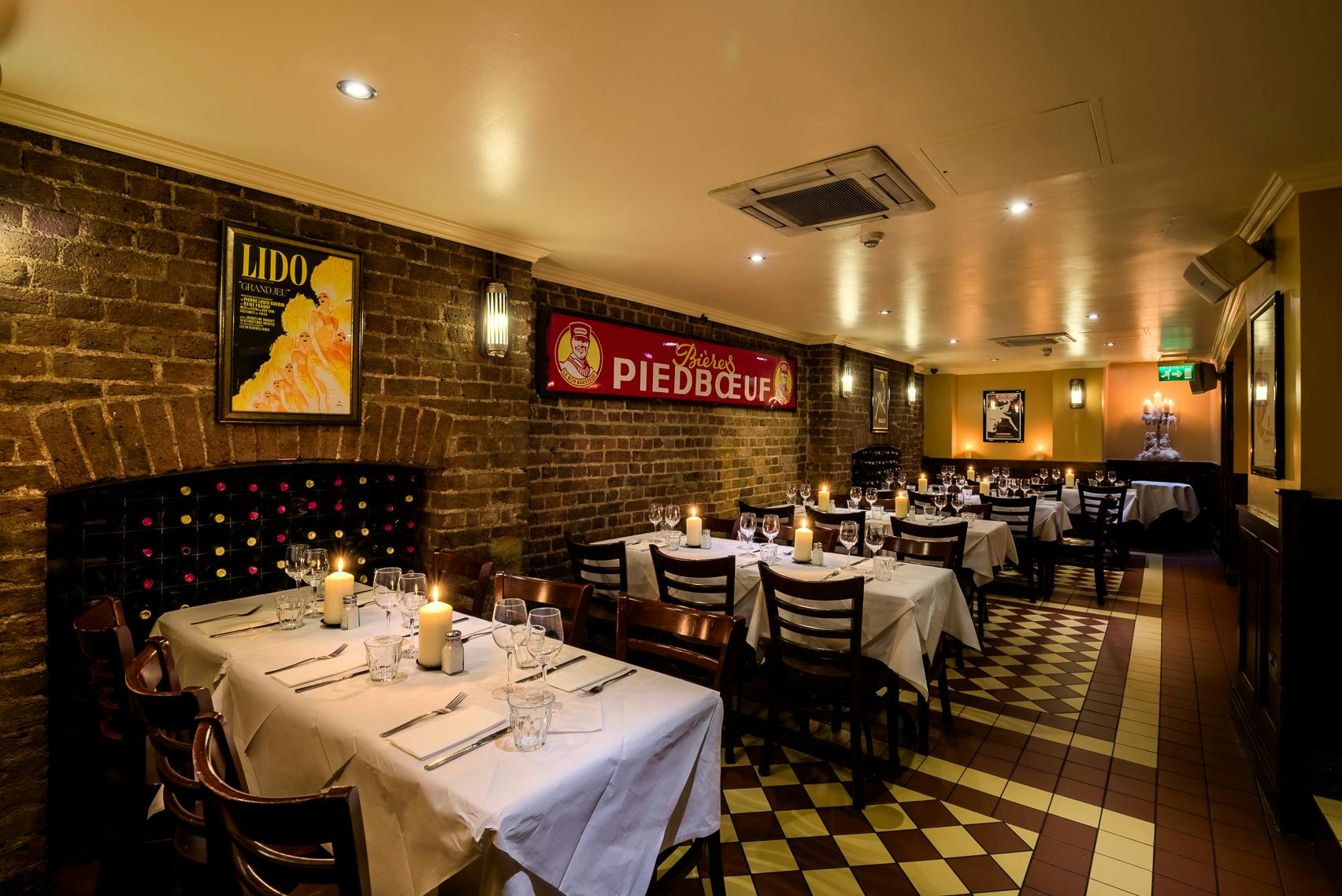 Cozy restaurant with rustic brick walls, perfect for intimate gatherings and events.