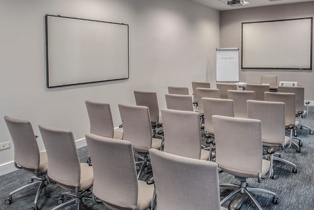 Small theater-style meeting room with whiteboards for agile workshops and training sessions.