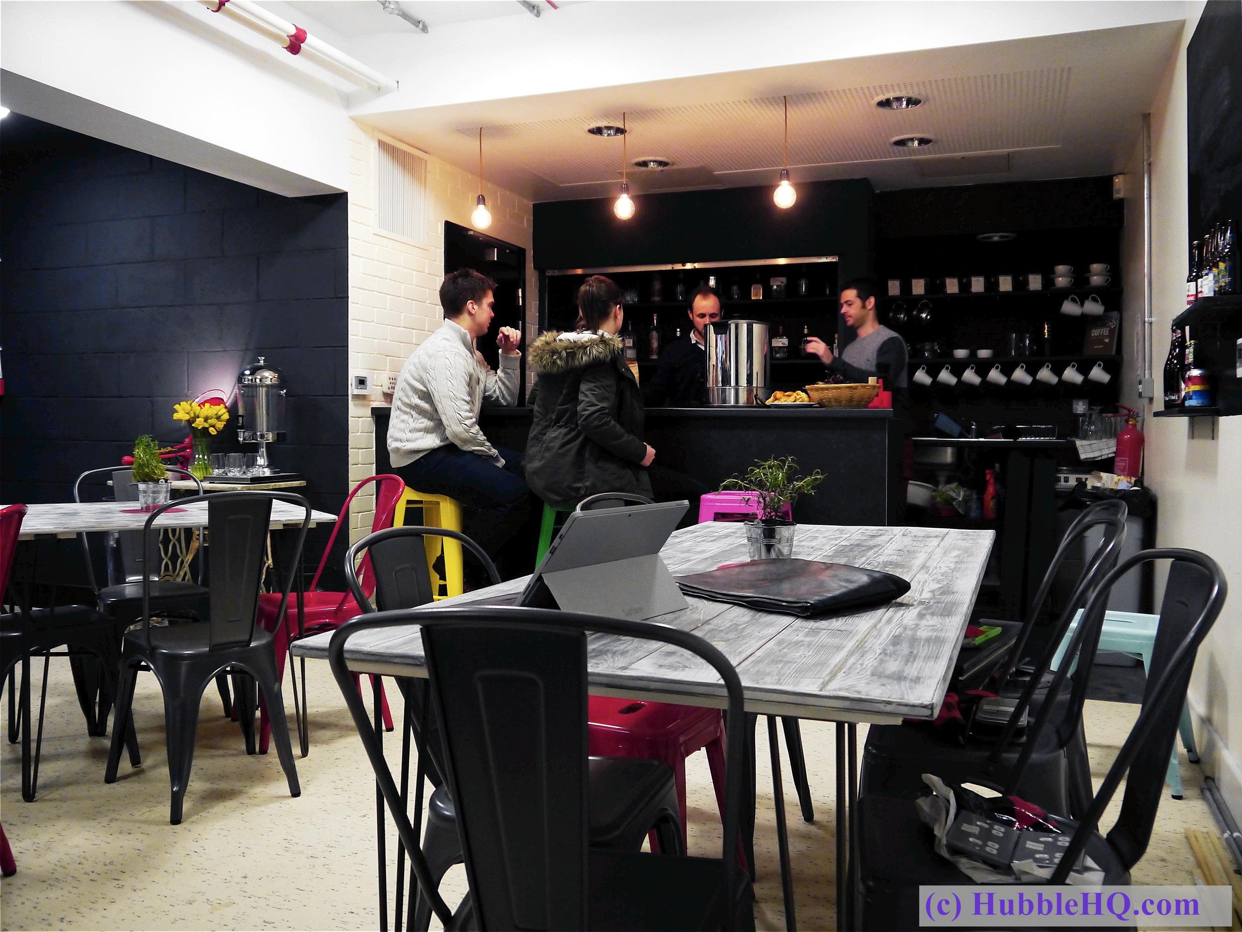 Vibrant café with colorful seating, ideal for networking and informal meetings. - Banner
