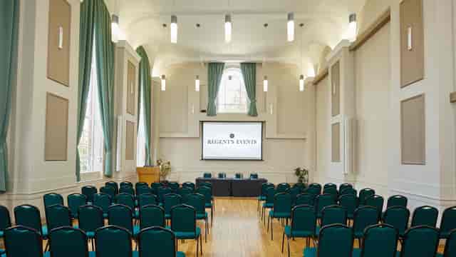 Herringham Hall event space with green chairs, ideal for corporate meetings and conferences.