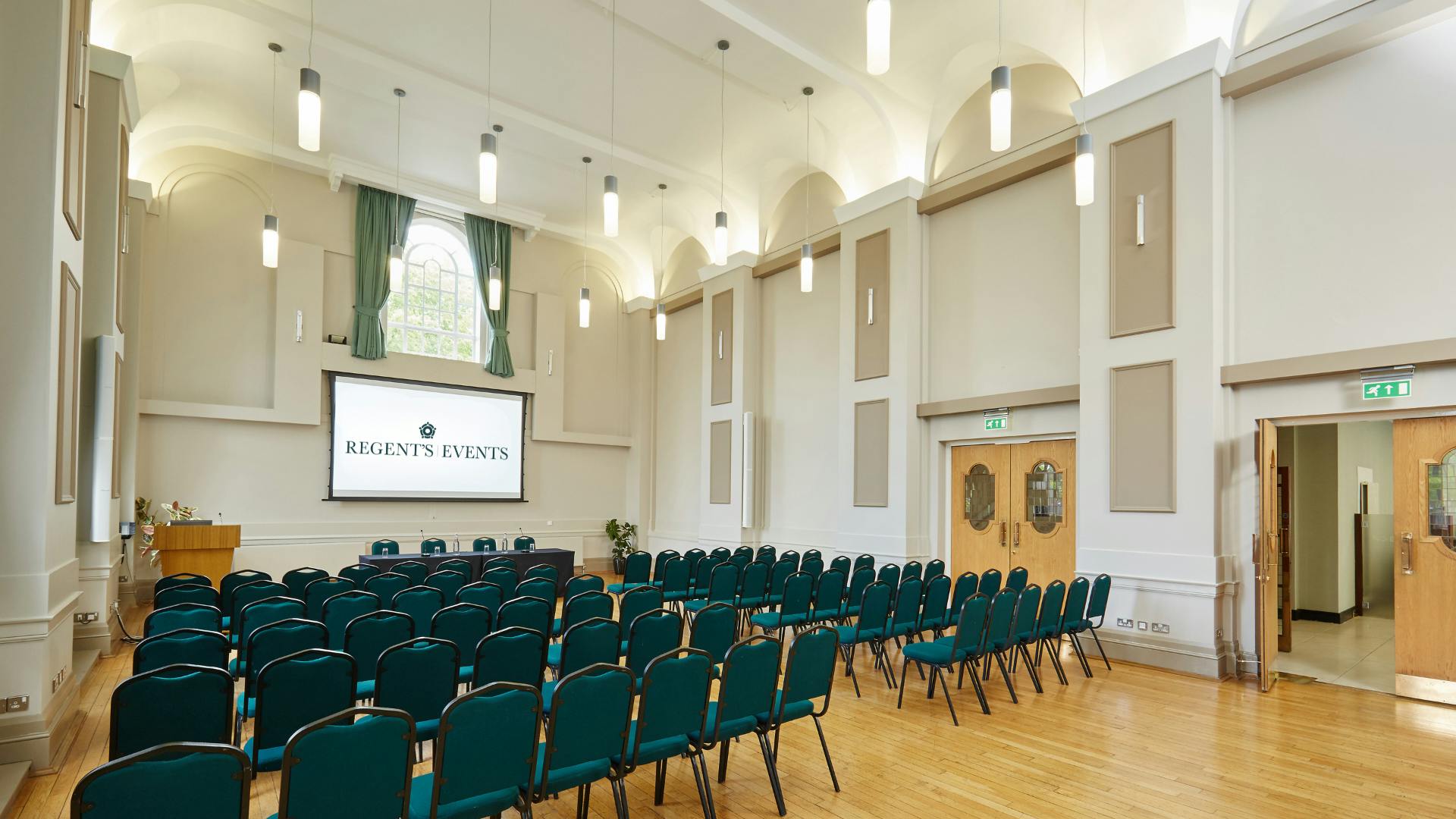 Herringham Hall event space with teal chairs, ideal for conferences and seminars.