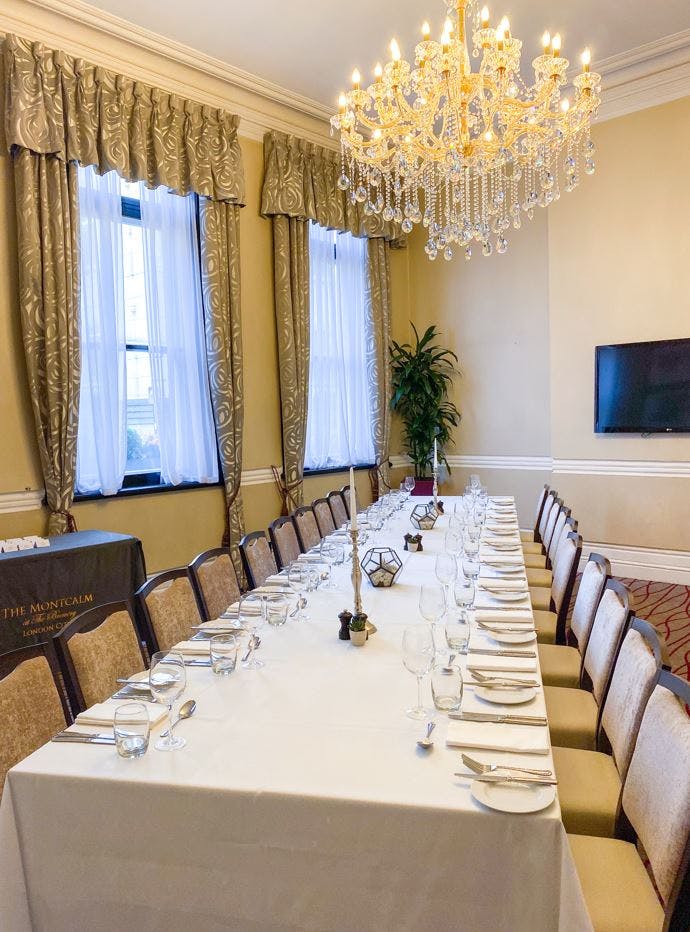 Elegant Melville Room with fine tableware for corporate events and dining gatherings.