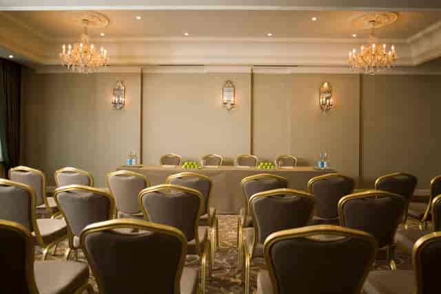 Sophisticated meeting room at L'Horizon Beach Hotel with elegant chandeliers and plush seating.