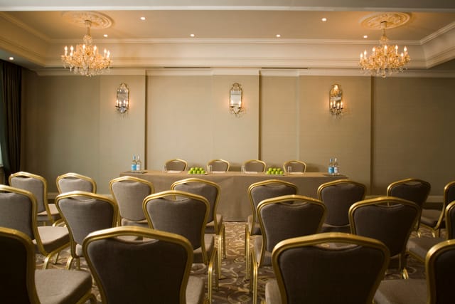 Sophisticated meeting room at L'Horizon Beach Hotel with elegant chandeliers and plush seating.