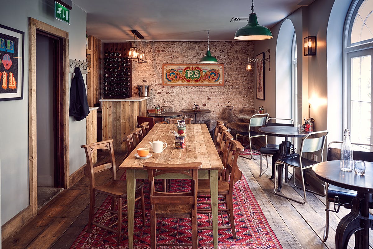 Cozy Club Room at Artist Residence London with rustic decor for meetings and gatherings.