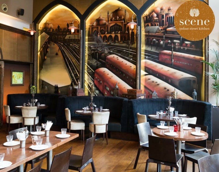 Stylish Scene Indian Street Kitchen with train mural, perfect for events and dining.