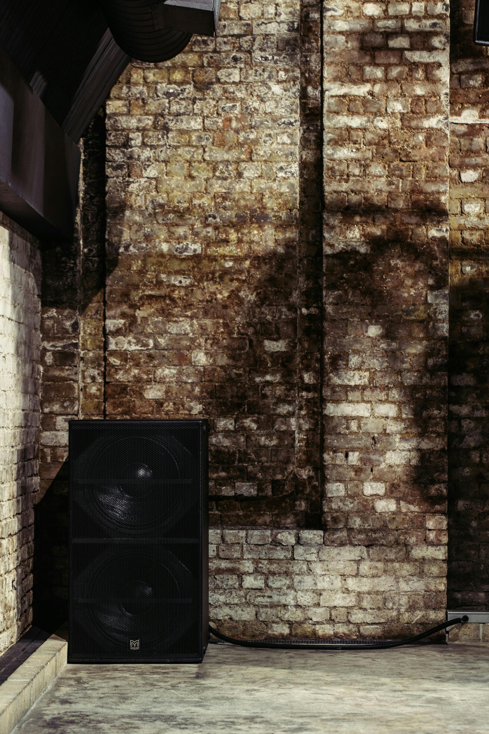 Rustic Baby Box venue with exposed brick, ideal for creative events and live performances.