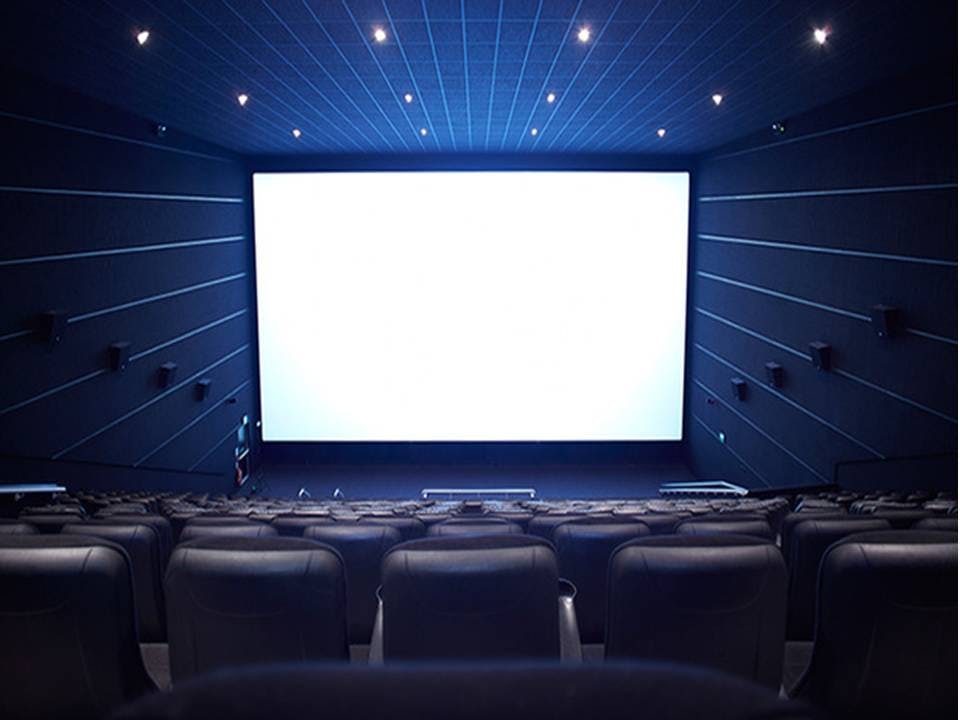 Spacious cinema auditorium with plush seating for corporate events and film screenings.