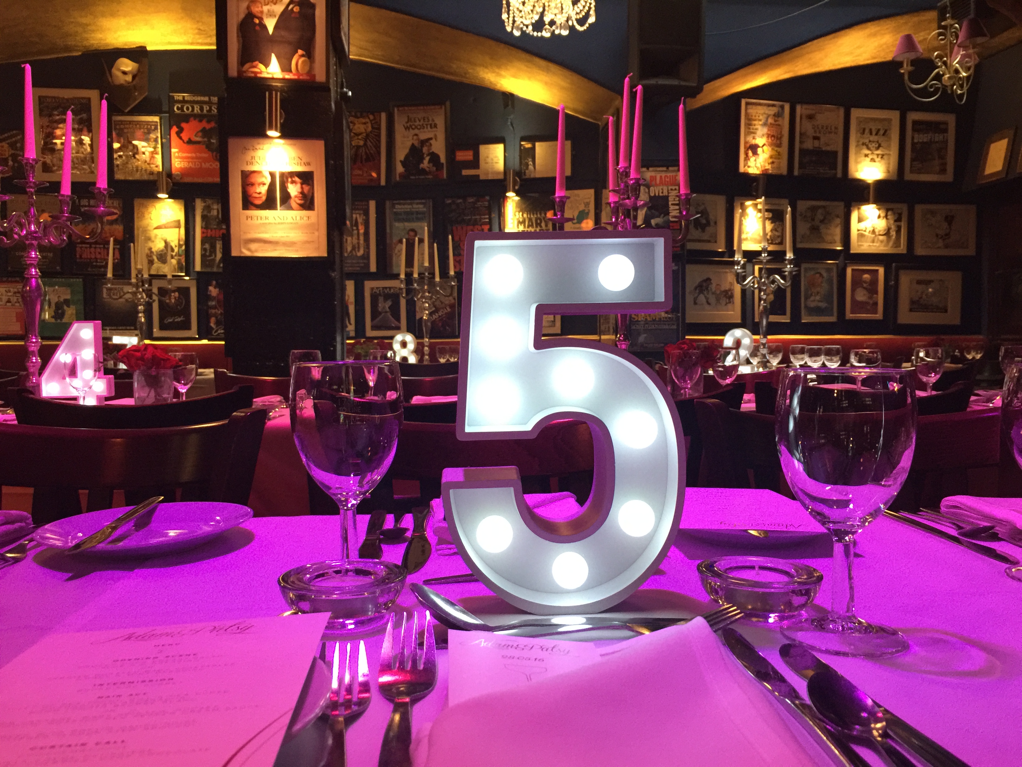 Elegant dining table setup at Phoenix Arts Club for events, featuring warm lighting and decor. - Banner