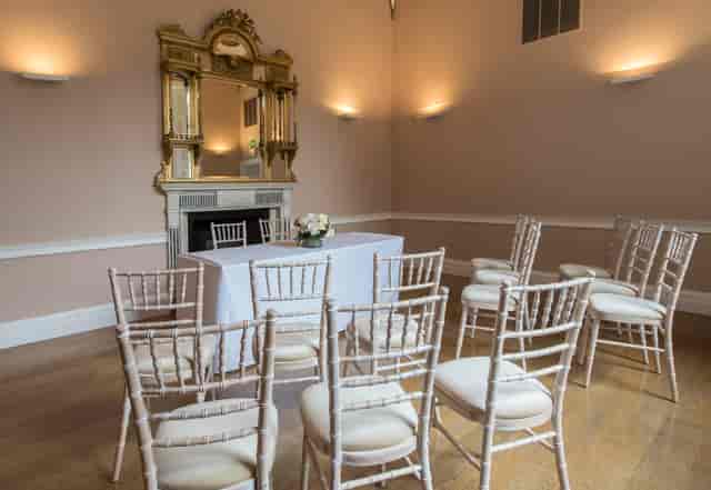 Elegant meeting room with floral centerpiece, ideal for intimate gatherings and networking.