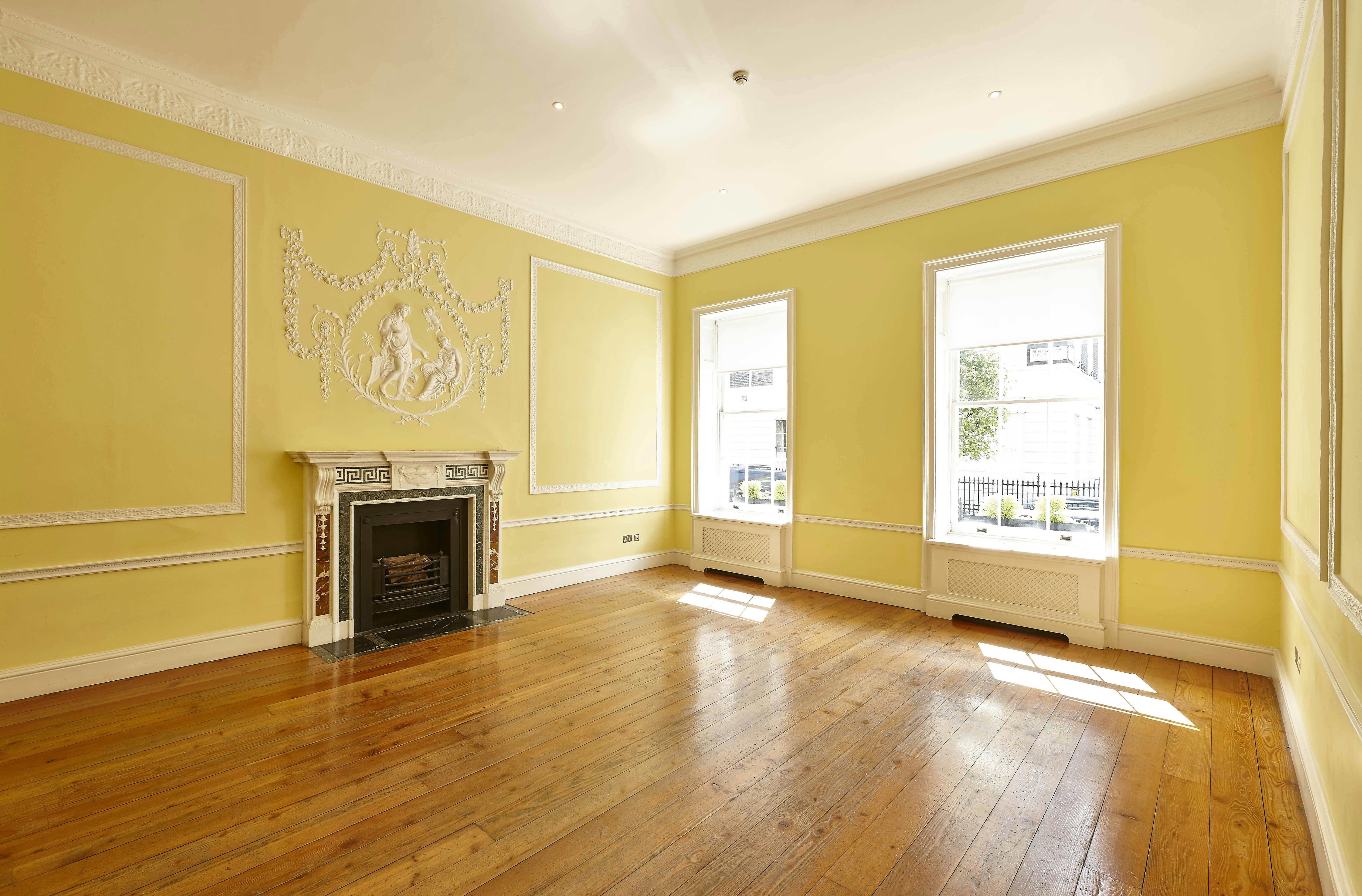 Elegant meeting space in Hutchison Room, Asia House with natural light and fireplace.