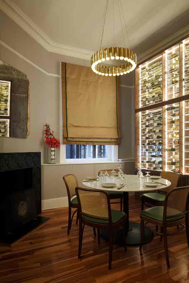 Elegant wine room with round table, ideal for corporate events and private dinners.