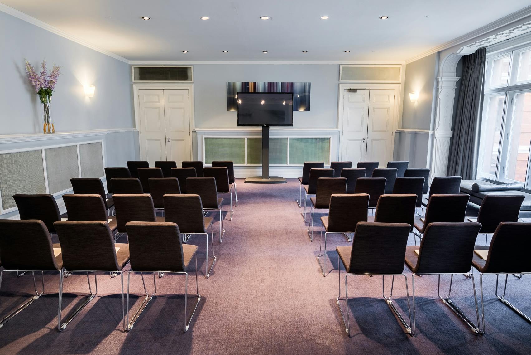 Modern meeting room at Andaz London with sleek chairs, ideal for corporate events.