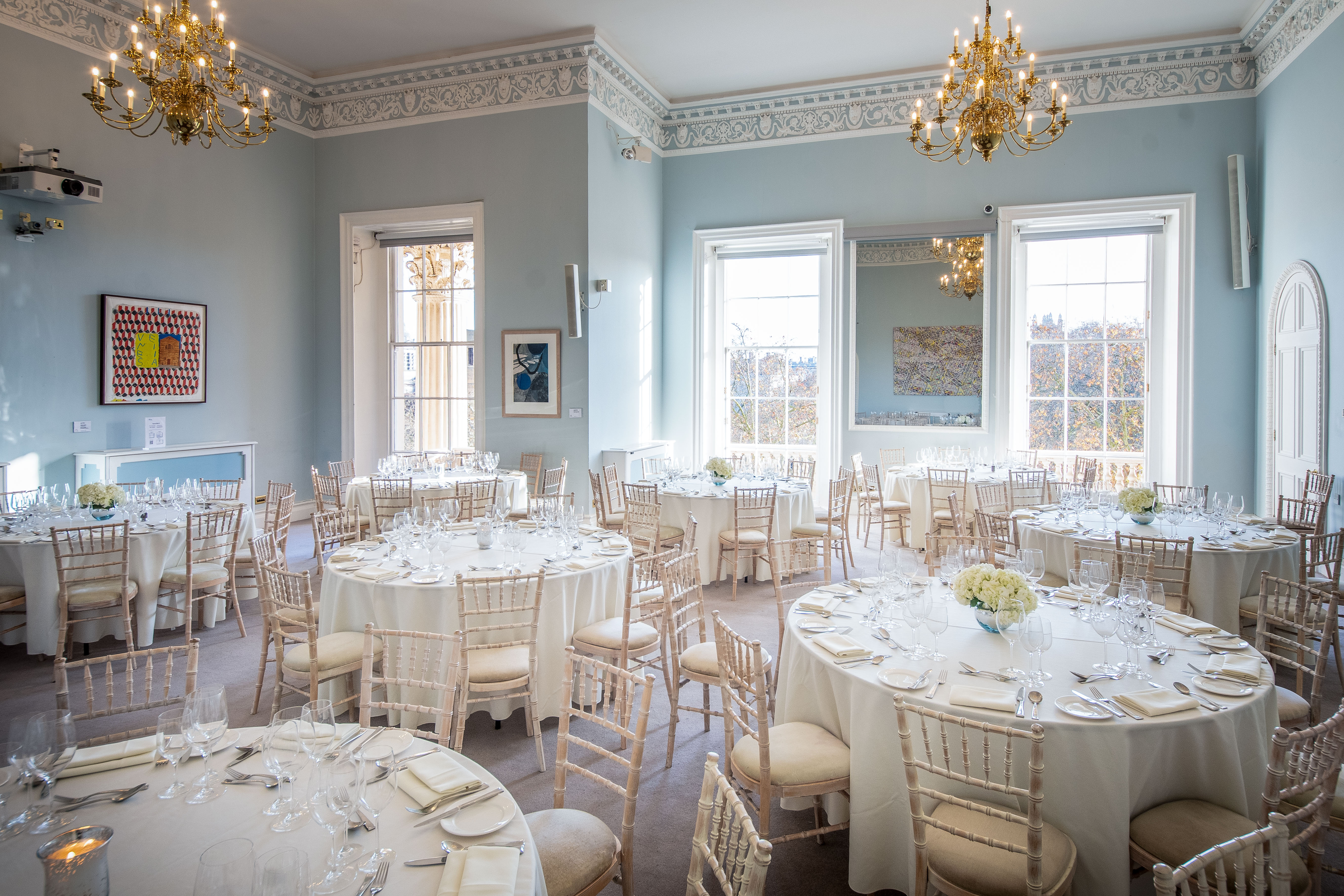 Beatrice Webb Room: elegant event space with round tables, ideal for corporate meetings and celebrations. - Banner