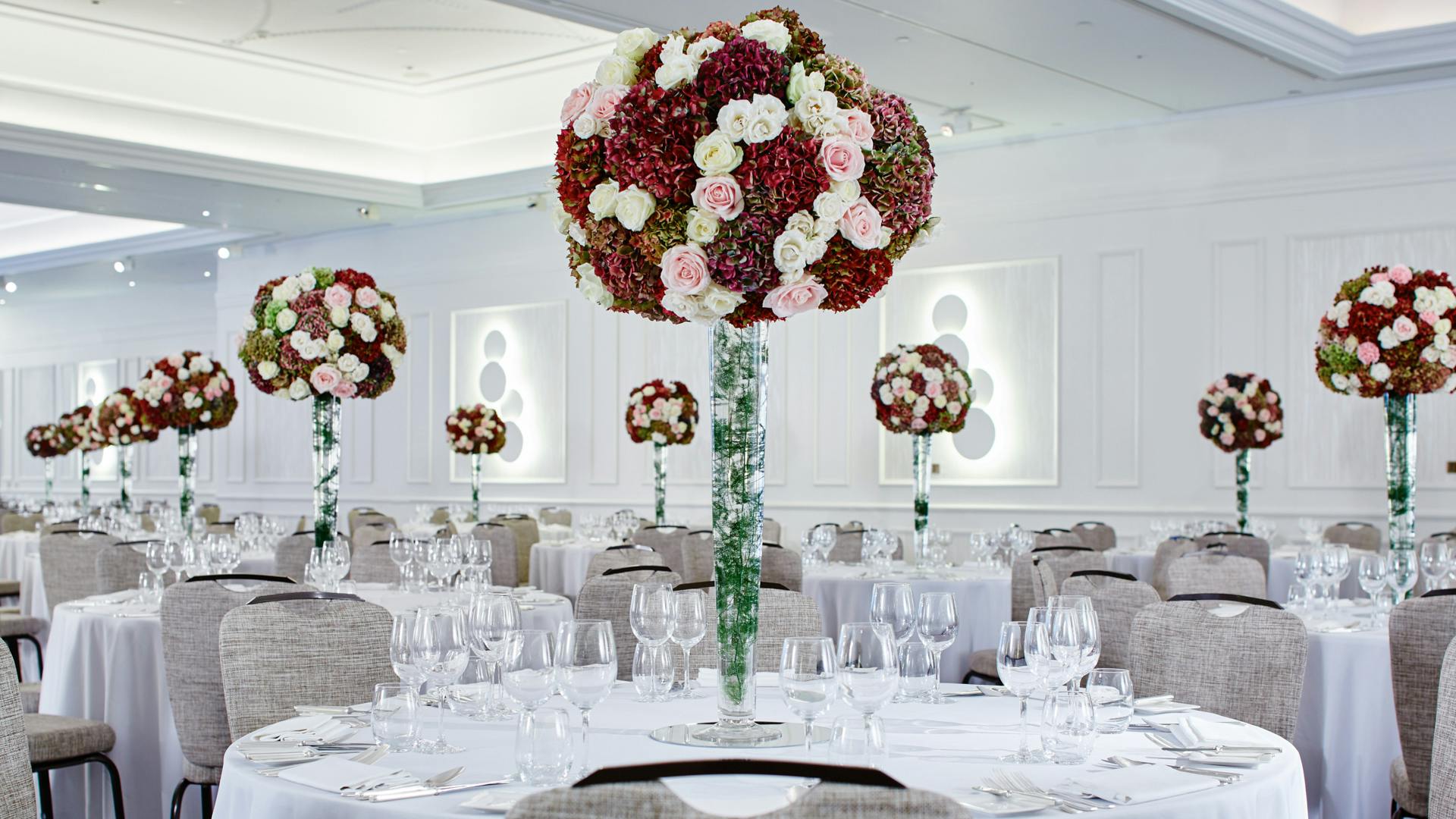 Elegant banquet setting with tall floral centerpieces at Westminster Ballroom, London Marriott.