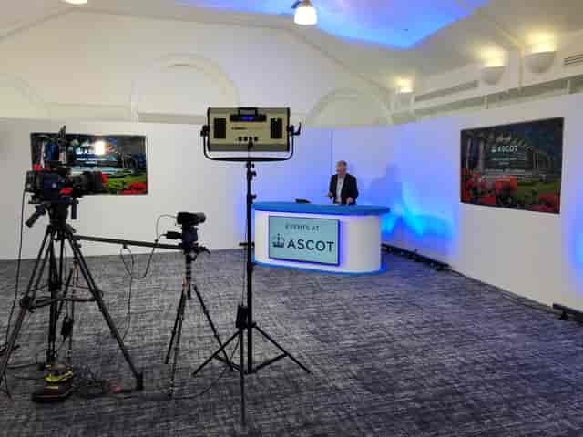 Virtual event setup in Pavilion Suite at Ascot Racecourse with sleek desk and professional lighting.