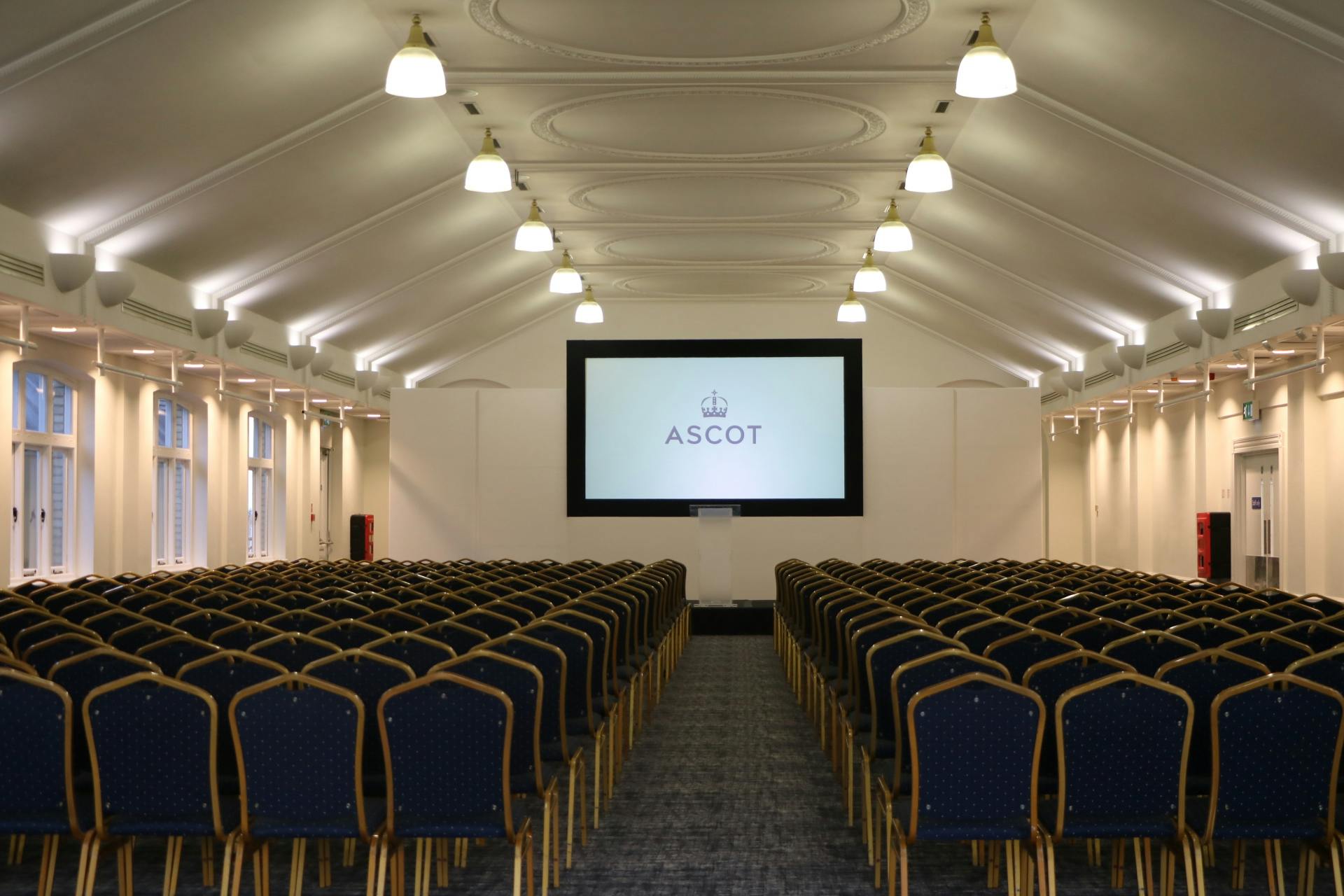 Pavilion Suite 2 at Ascot Racecourse, modern conference venue with blue chairs.