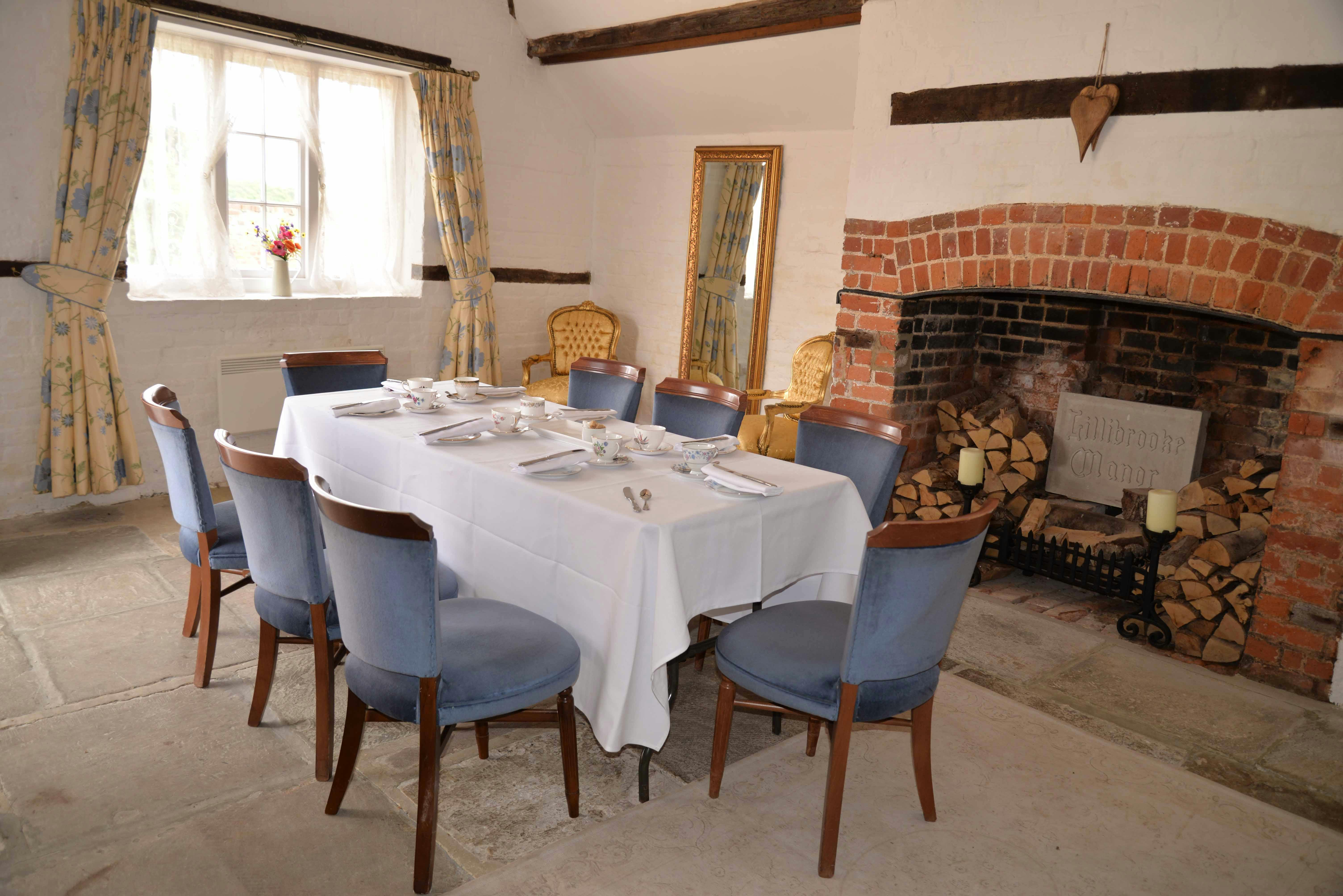 Cozy meeting space at Lillibrooke Manor with round table, perfect for workshops and gatherings.