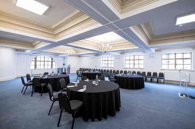 William Sangster in Central Hall Westminster, meeting space with round tables and natural light.