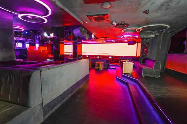 Modern event space with neon lighting for versatile gatherings and presentations.