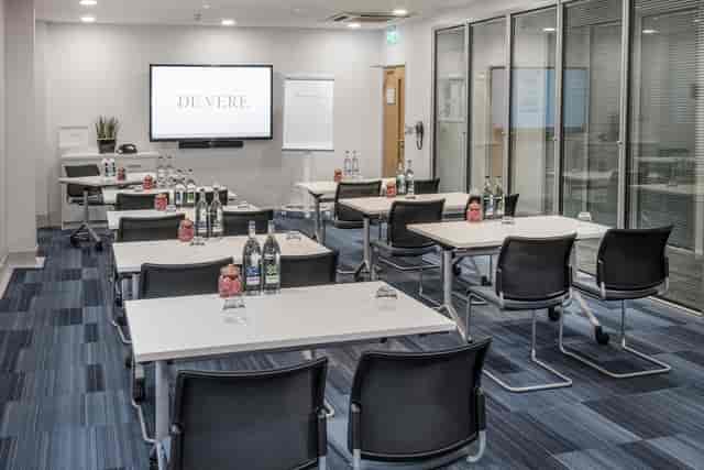 Trafalgar Suites meeting room with classroom setup for professional events and presentations.
