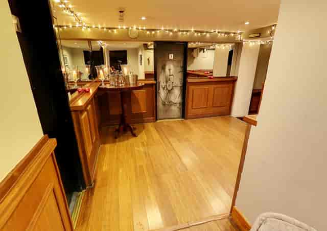 Seasons Basement Bar with wood paneling for intimate cocktail receptions and networking mixers.