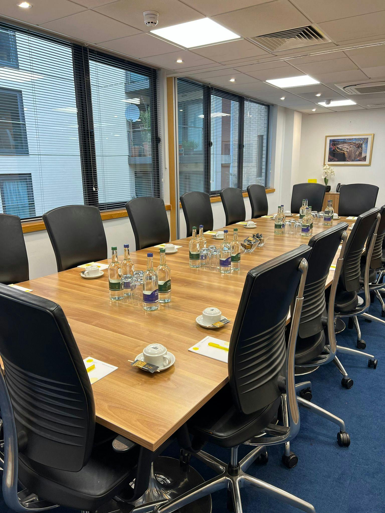 Dali Suite meeting room with wooden table, perfect for corporate events and workshops.