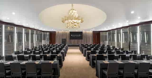Ballroom at Bulgari Hotel London, featuring sleek tables for corporate events and luxury chandelier.