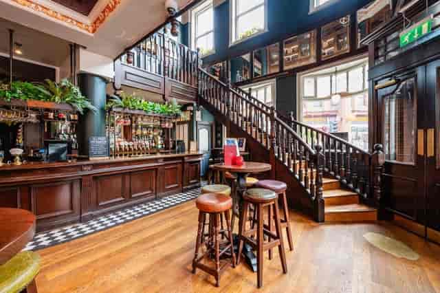 Sawyers Arms dining area with dark-wood decor, ideal for conference receptions and networking events.